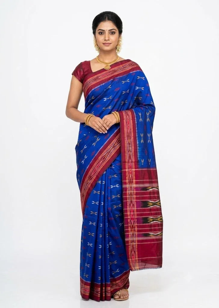 Real product view of royal blue handloom Pochampally silk saree fabric with maroon geometric ikat pattern.