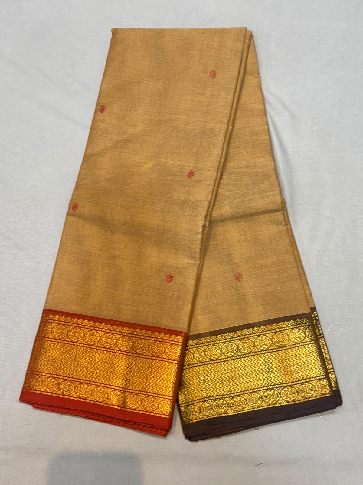 Handloom biscuit beige pure Kanchi cotton saree with red floral buttas and dual-tone Ganga Jamuna zari borders in red and dark brown