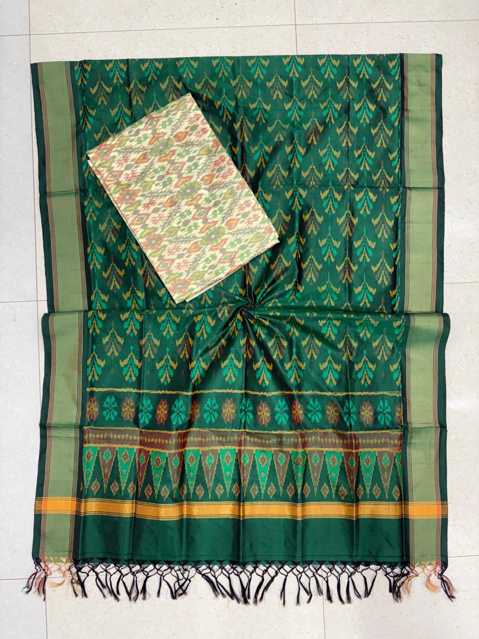 Emerald green and cream Pochampally Ikat silk unstitched dress material set with traditional handwoven geometric motifs and a matching tasseled dupatta.