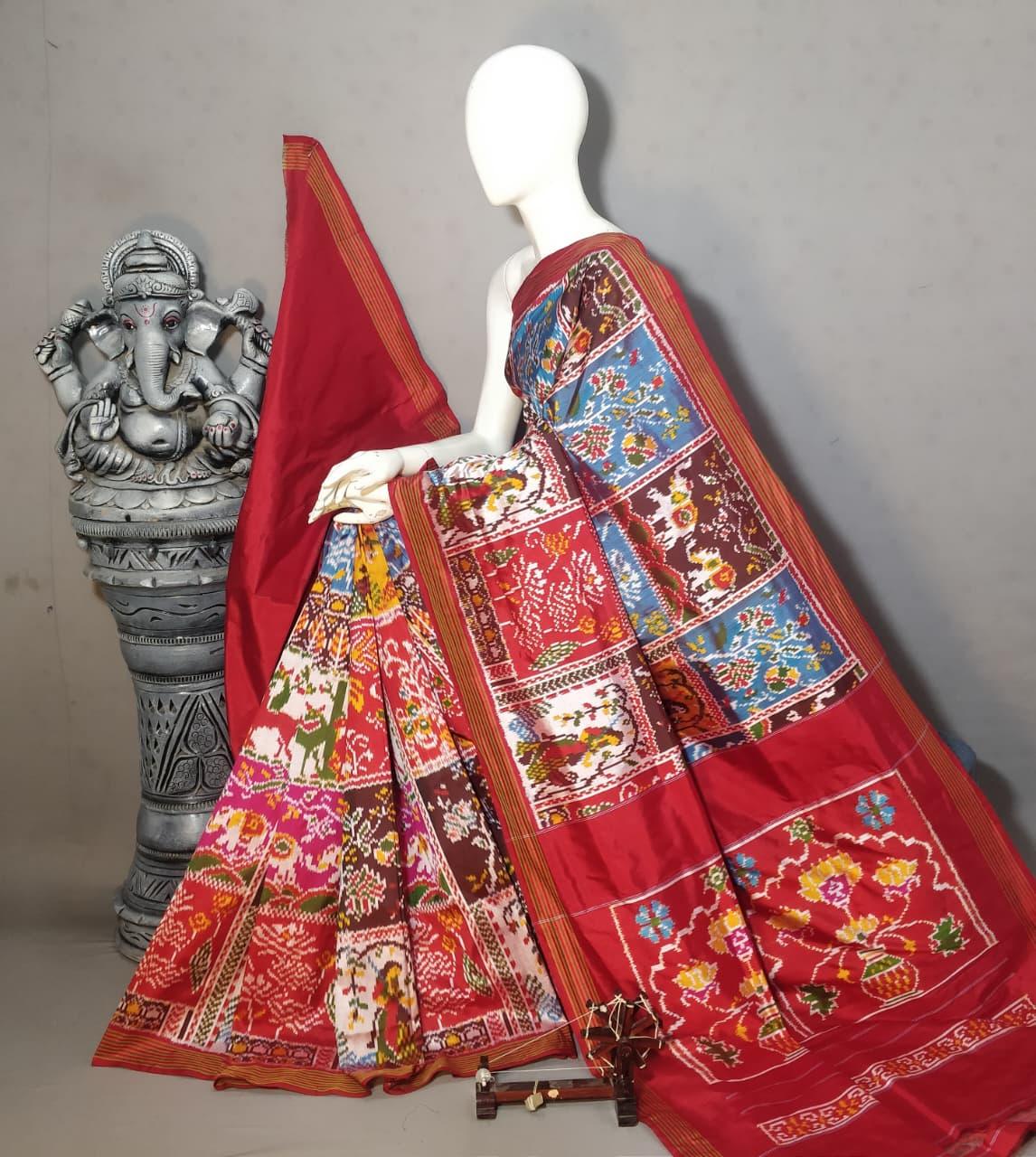 Handloom Pochampally Ikkat silk saree showcasing a multicolored grid pattern with traditional bird and elephant motifs on a red base featuring a Kalash border.