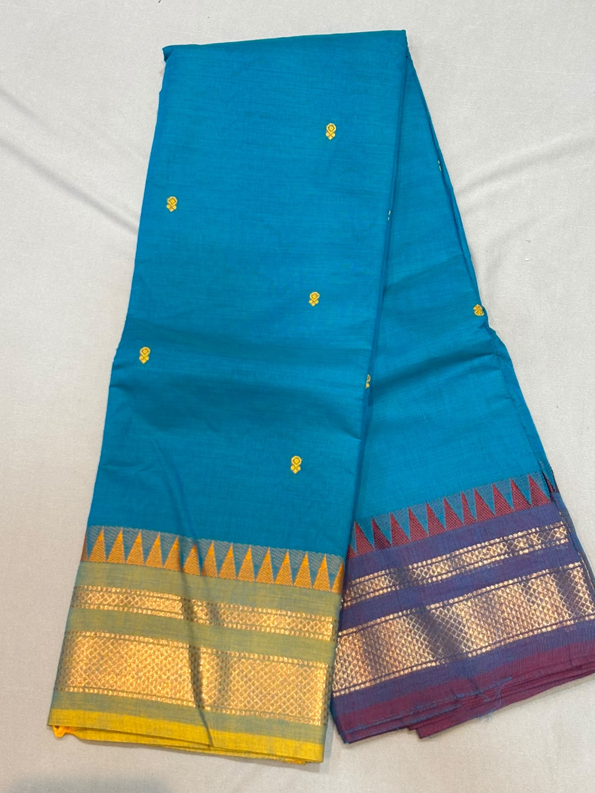 Handloom peacock blue pure Kanchi cotton saree with yellow floral buttas and Ganga Jamuna temple borders in mustard yellow and wine purple with gold zari