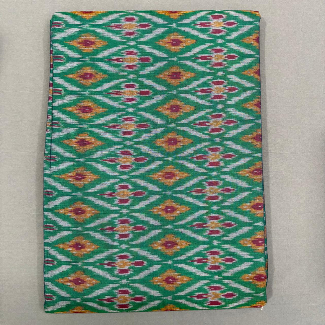 Handwoven Pochampally Ikkat Sico emerald green fabric with magenta and yellow diamond floral motifs