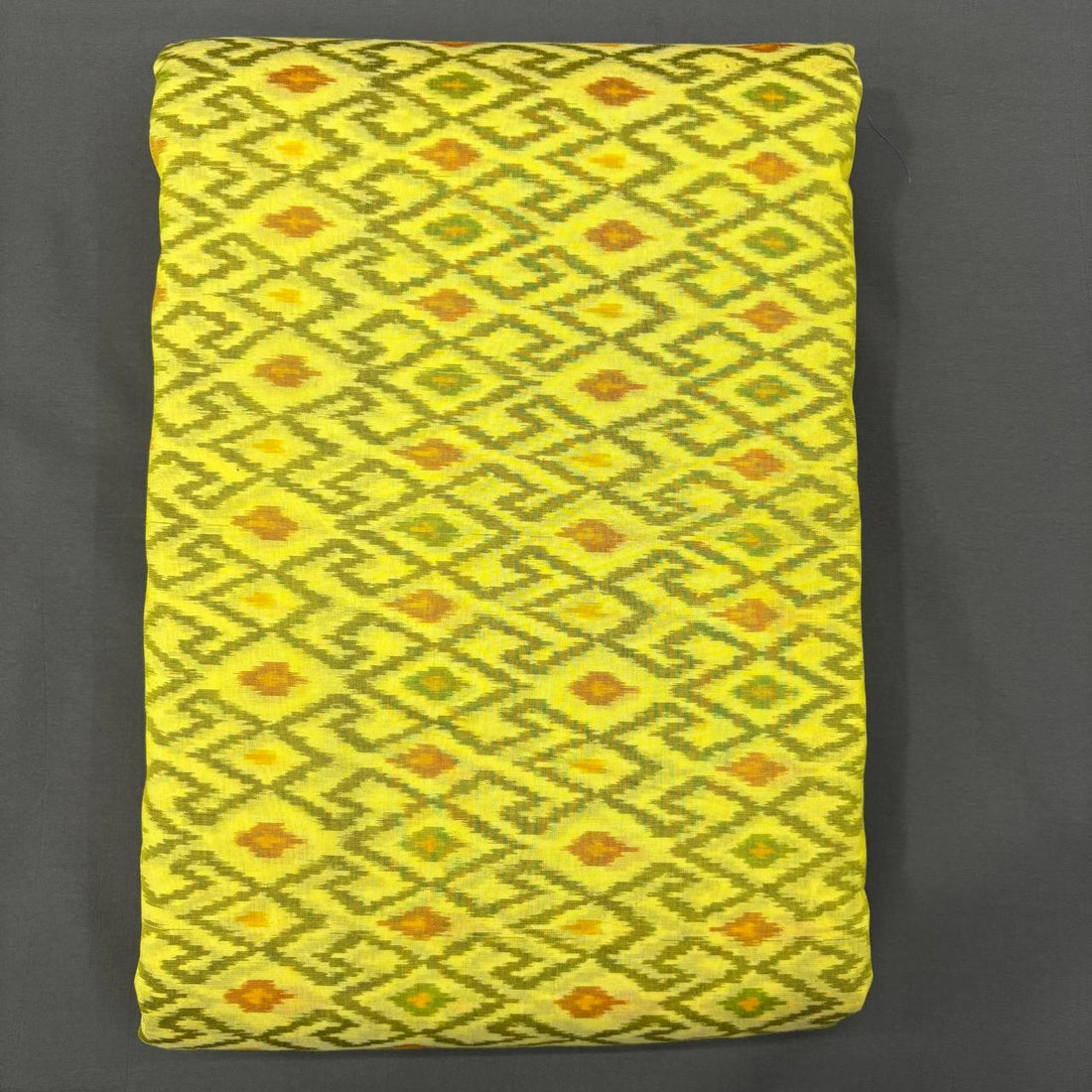 Handwoven Pochampally Ikkat Sico lemon yellow fabric with olive green geometric diamond motifs