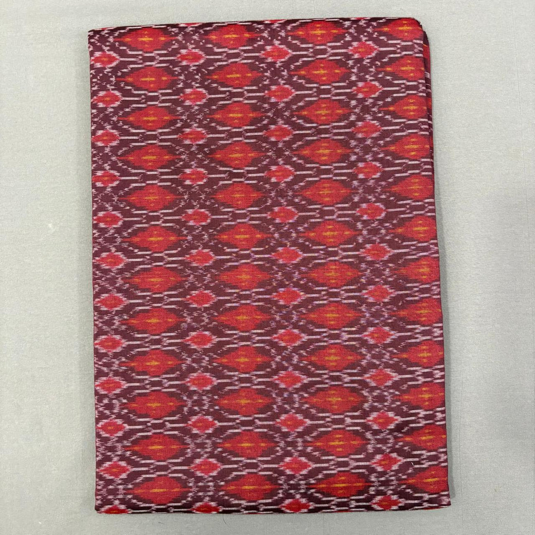 Handwoven Pochampally Ikkat Sico maroon fabric with crimson red and yellow diamond motifs