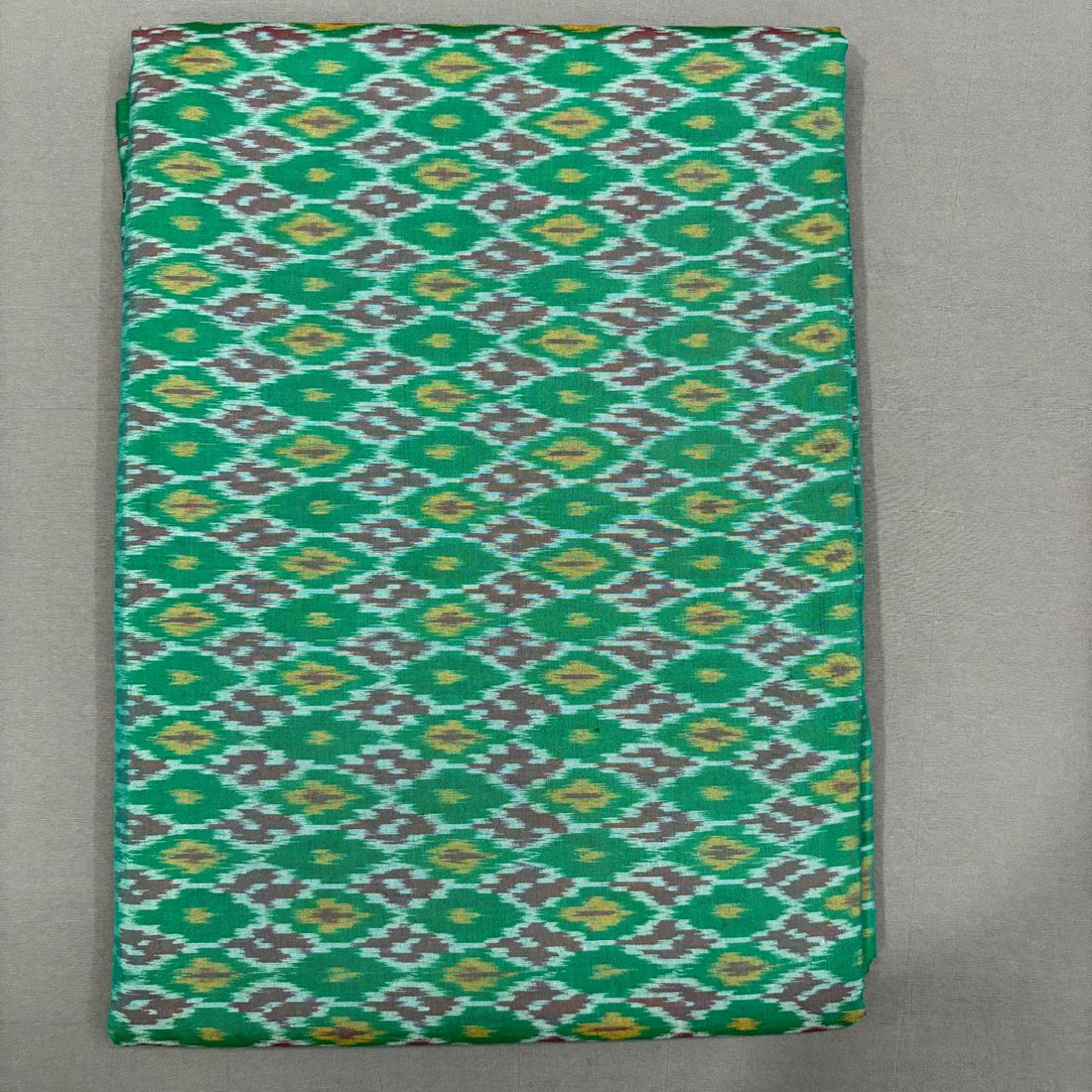 Handwoven Pochampally Ikkat Sico sea green fabric with yellow and grey diamond motifs