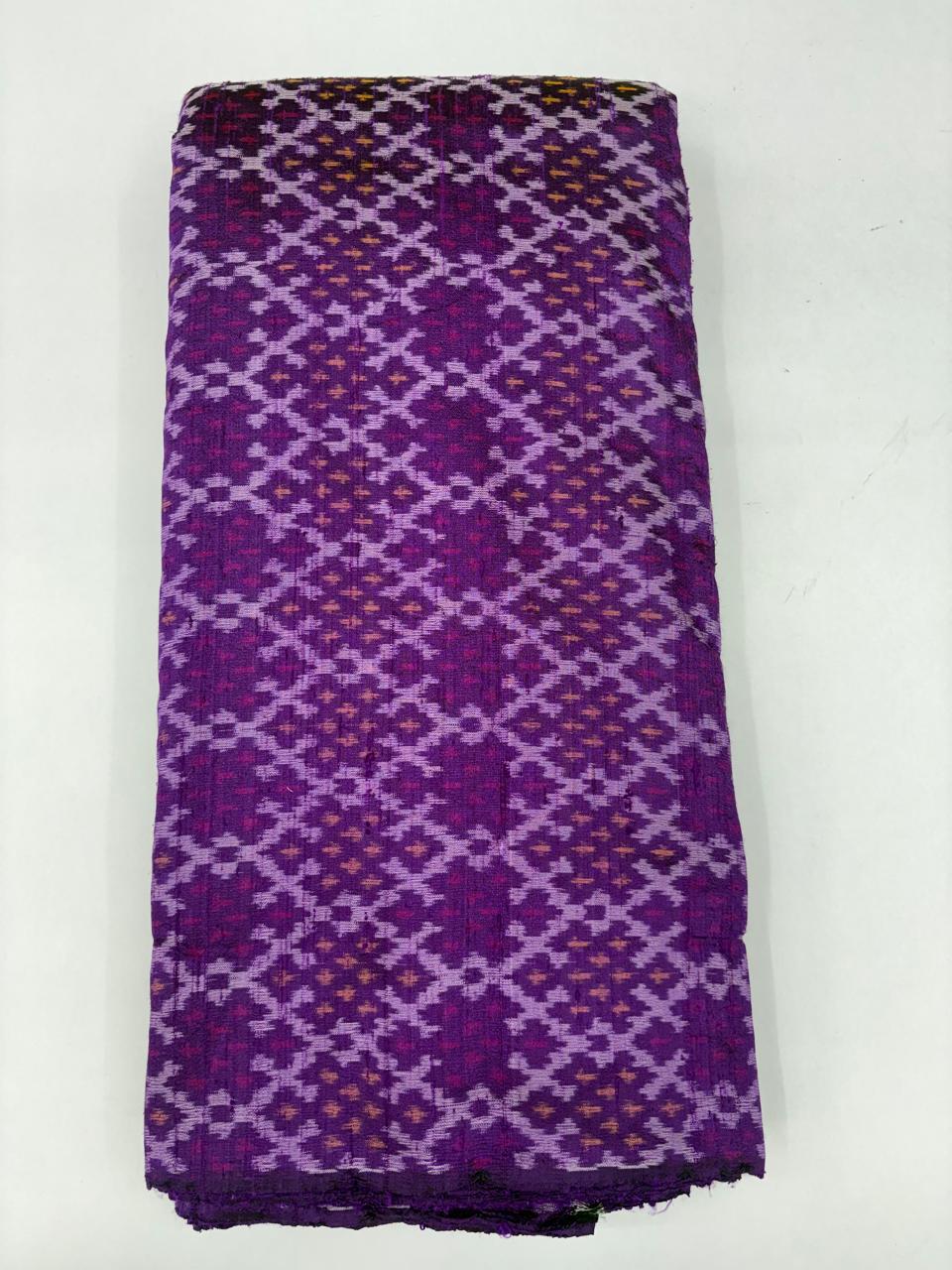 Folded bolt of deep purple pure raw silk fabric featuring an interlocking geometric lavender Ikat lattice weave with Silk Mark authenticity