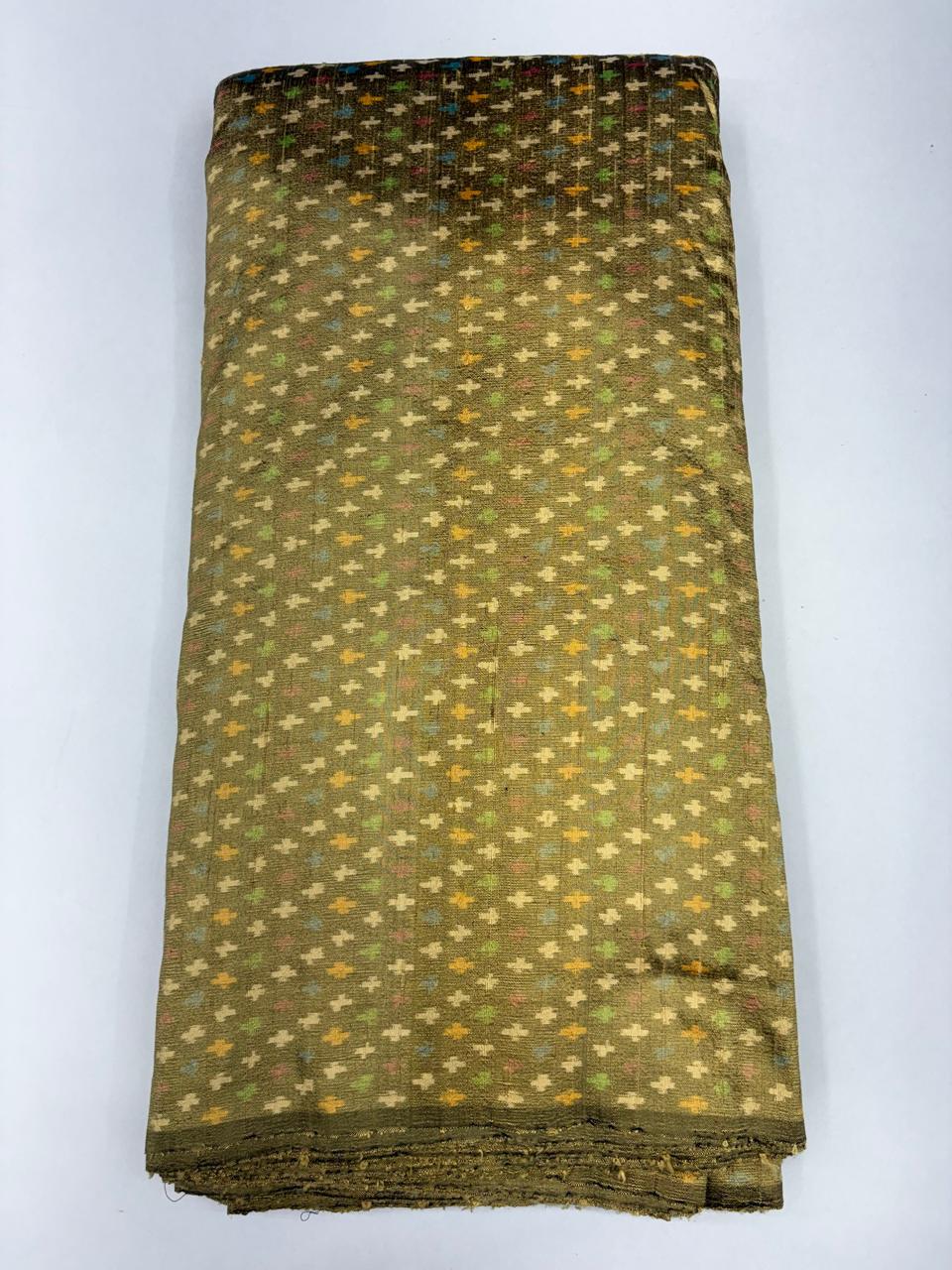 Folded bolt of olive green pure raw silk fabric featuring all-over multicolor geometric cross Ikat motifs with Silk Mark quality weave