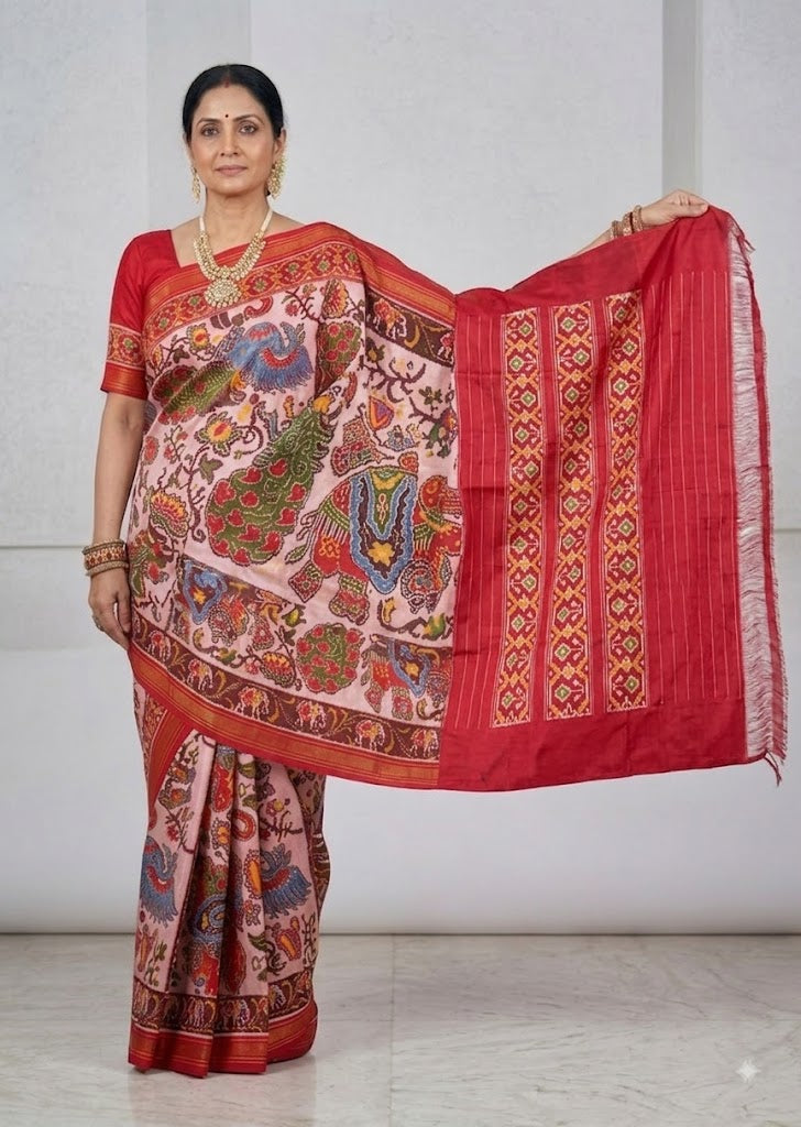 Model wearing hand-woven Ikkat Patola silk saree with elephant Kalamkari print and red Ikat pallu