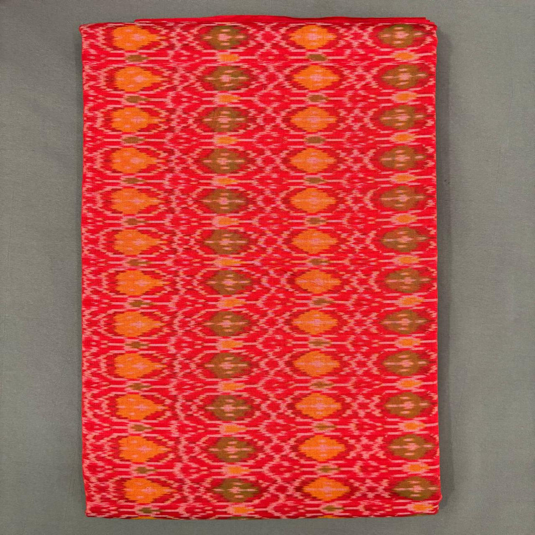 Bright red and orange Pochampally ikkat sico unstitched dress material with a geometric pattern.