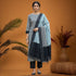 Pochampally Double Ikkat Cotton Suit showcasing a gray top, black dupatta, and coordinated pants against a warm backdrop.