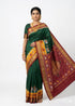 Woman wearing authentic Dark Green Pochampally Ikkat Silk Saree featuring traditional elephant motifs, maroon zari border, and handwoven silk pallu