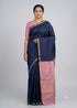 Elevate your festive wardrobe with this stunning navy blue handloom silk saree. It features a beautiful pastel pink contrasting pallu and blouse, finished with a classic gold zari border. Perfect for weddings, festivals, and special occasions. Buy online now!