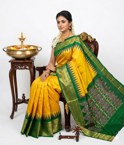 A beautiful traditional Indian woman seated on a wooden chair, modeling a bright yellow Pochampally Ikkat silk saree with an emerald green zari border and intricate geometric diamond pallu. She is wearing traditional gold jewelry and jasmine flowers in her hair, positioned next to a brass diya and floral bowl against a clean white background.