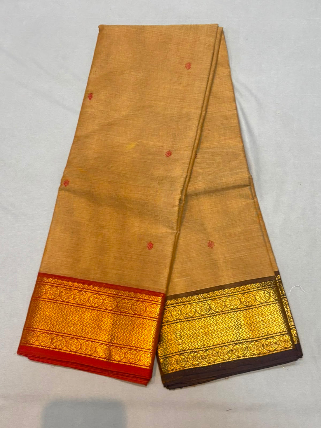 Handloom biscuit beige pure Kanchi cotton saree with red floral buttas and dual-tone Ganga Jamuna zari borders in red and dark brown