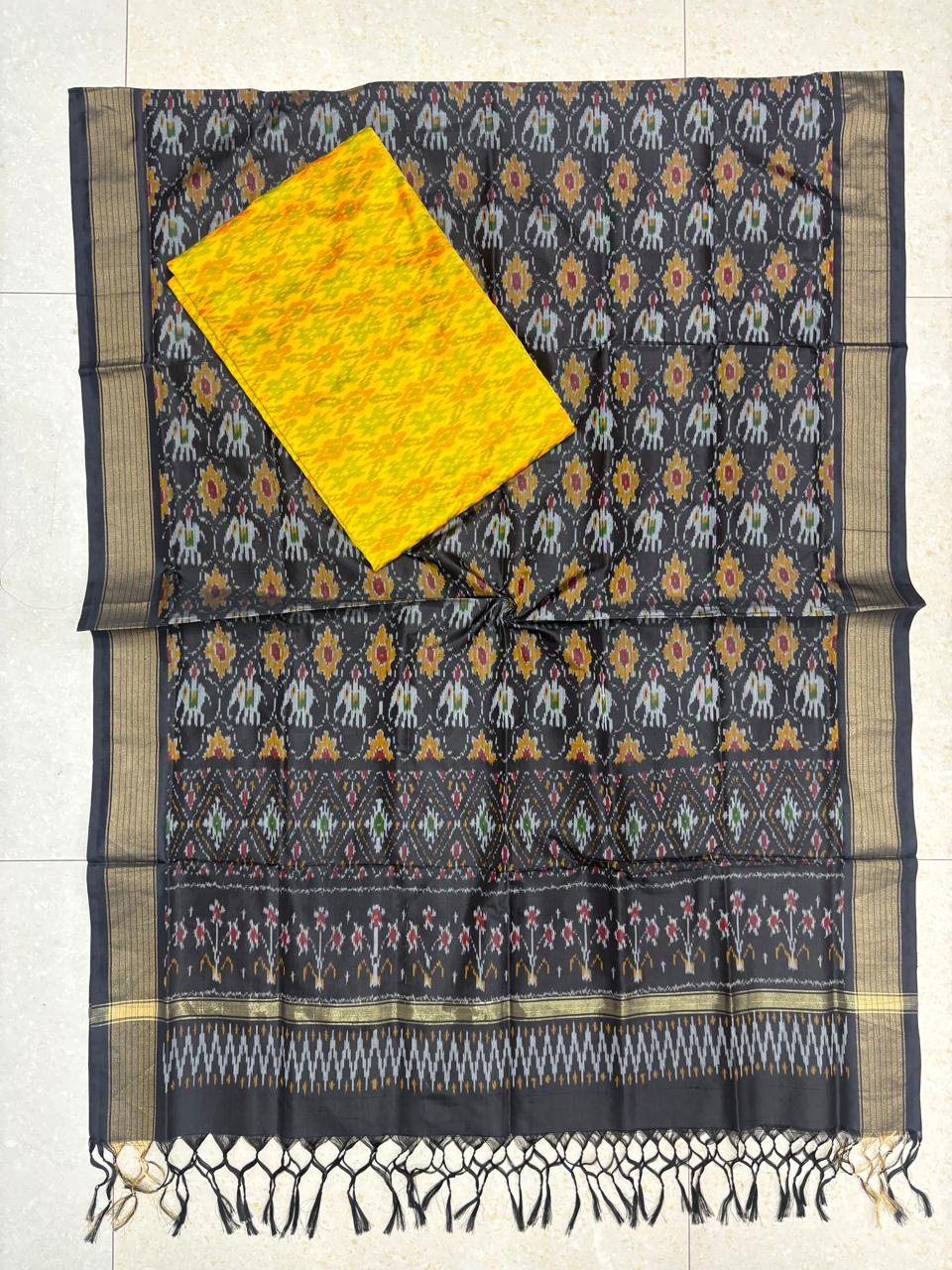 Charcoal black and yellow Pochampally Ikat silk unstitched dress material set featuring handwoven bird motifs, a detailed geometric and floral pattern border, and knotted tassels