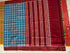 Flat lay of an authentic double ikat patola silk saree with a bright blue geometric patterned body, maroon striped pallu, and Silk Mark certification