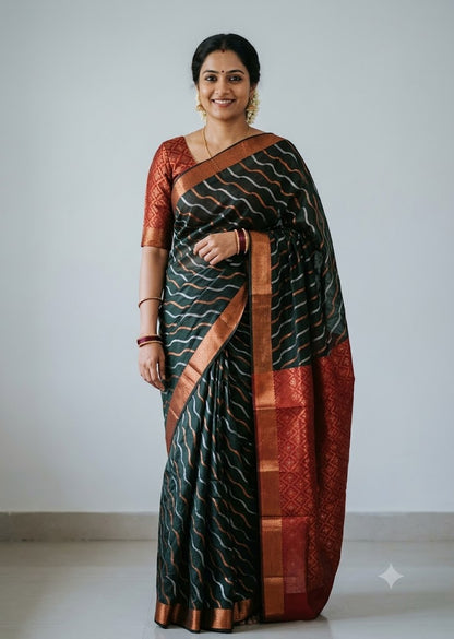 Woman wearing a traditional dark bottle green Kuppadam Pattu saree with wavy silver and copper zari stripes, copper zari border, and contrast maroon red floral brocade pallu and blouse.