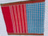 Flat lay of an authentic double ikat patola silk saree with a bright blue geometric patterned body, red striped pallu, and Silk Mark certification