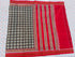 Flat lay of an authentic double ikat patola silk saree with a charcoal black geometric patterned body, red striped pallu, and Silk Mark certification