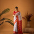 Flat layout view of a pure handloom cream Pochampally Ikkat silk saree with an elephant pattern grid body and a contrasting maroon zari pallu.