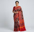 Traditional Indian woman wearing authentic crimson red Ikkat Patola silk saree with elephant motifs against studio backdrop