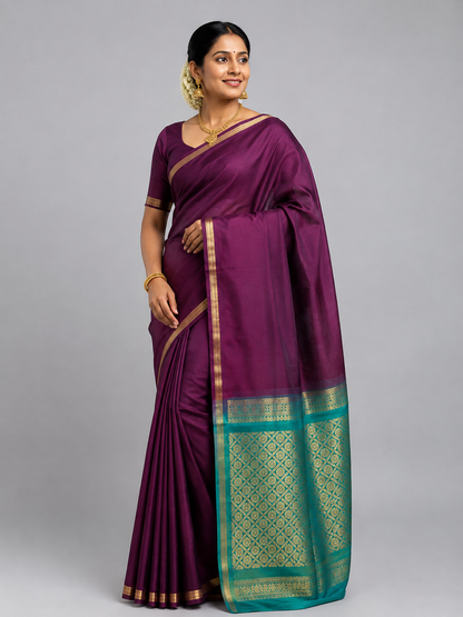Traditional Indian model wearing a Deep Wine Kanchi Soft Silk Saree with turquoise green zari woven pallu, antique gold border, Silk Mark Certified handloom saree.