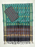 Bottle and black Pochampally Ikat silk unstitched dress material set featuring handwoven swan motifs, a detailed multi-colored geometric diamond border, and black tassels.