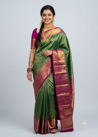 A traditional Indian woman posing in a vibrant green Dharmavaram silk saree with a contrasting magenta and gold zari border, pallu, and matching magenta blouse against a studio backdrop