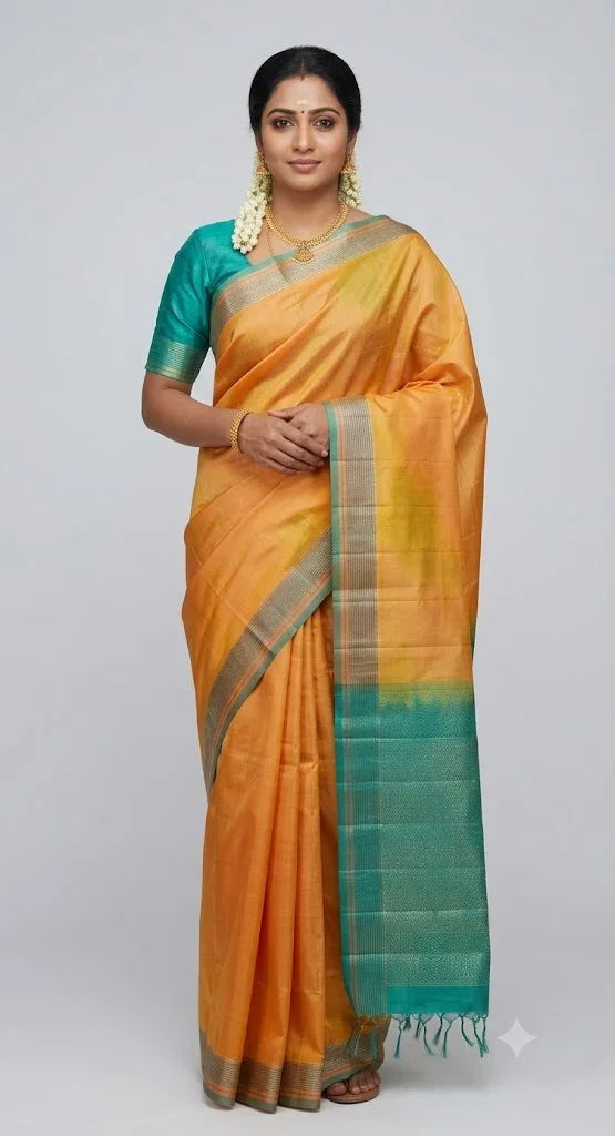 Indian woman wearing a traditional muted gold Kanchi soft silk saree paired with a teal green blouse and gold zari pallu against a neutral studio backdrop