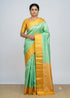 Traditional Indian woman wearing a sea green Kanchi soft silk saree with a yellow gold zari border and matching yellow blouse
