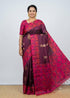 Traditional Indian woman wearing a deep wine Kanchi soft silk saree with golden leaf buttas and a bright magenta floral Jamdani weave border and blouse