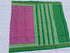 Flat lay of an authentic double ikat patola silk saree with a magenta geometric patterned body, bold green striped pallu, and Silk Mark certification