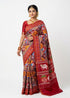 Woman modeling a traditional maroon Pochampally Ikat silk saree with geometric Patola patterns and a Pichwai cow motif pallu