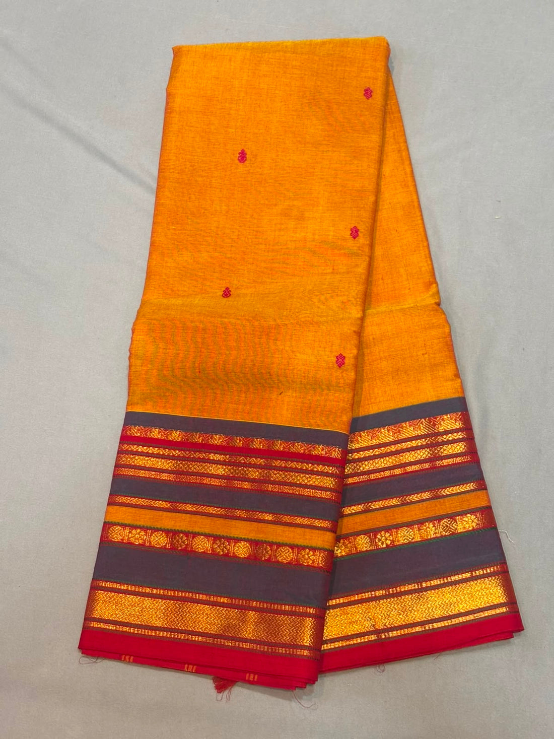 Mustard yellow Kanchi cotton saree with charcoal grey and red zari border with running blouse