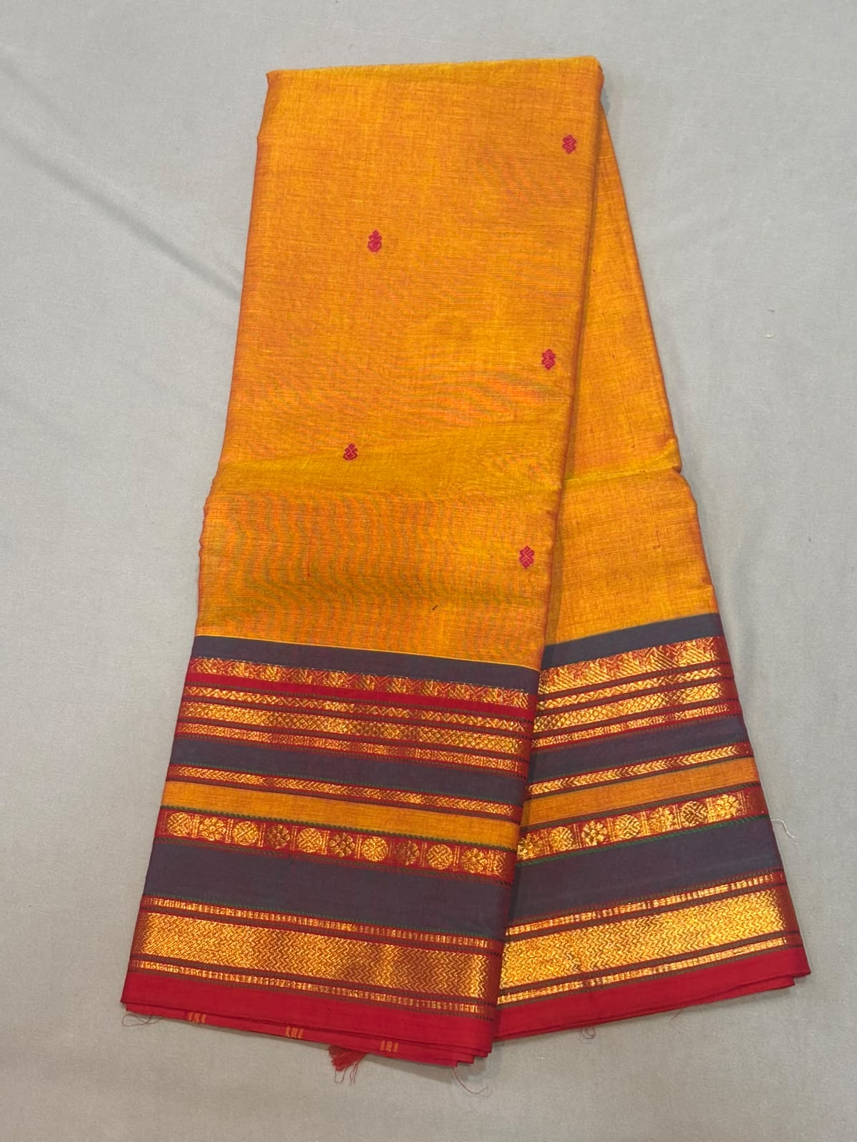 Mustard yellow Kanchi cotton saree with charcoal grey and red zari border with running blouse