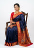 A person displaying a beautiful navy blue Semi Gadwal Paithani saree featuring small gold motifs, a vibrant red and gold zari border, and a rich gold pallu detailed with intricate, multi-colored peacock and floral designs.