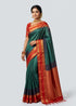 Traditional Indian woman wearing a peacock green silk saree with rich red gold zari border and brocade pallu