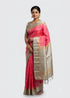 Model draping a pink Kanchi soft silk saree with a woven light gray silver zari pallu against a neutral backdrop