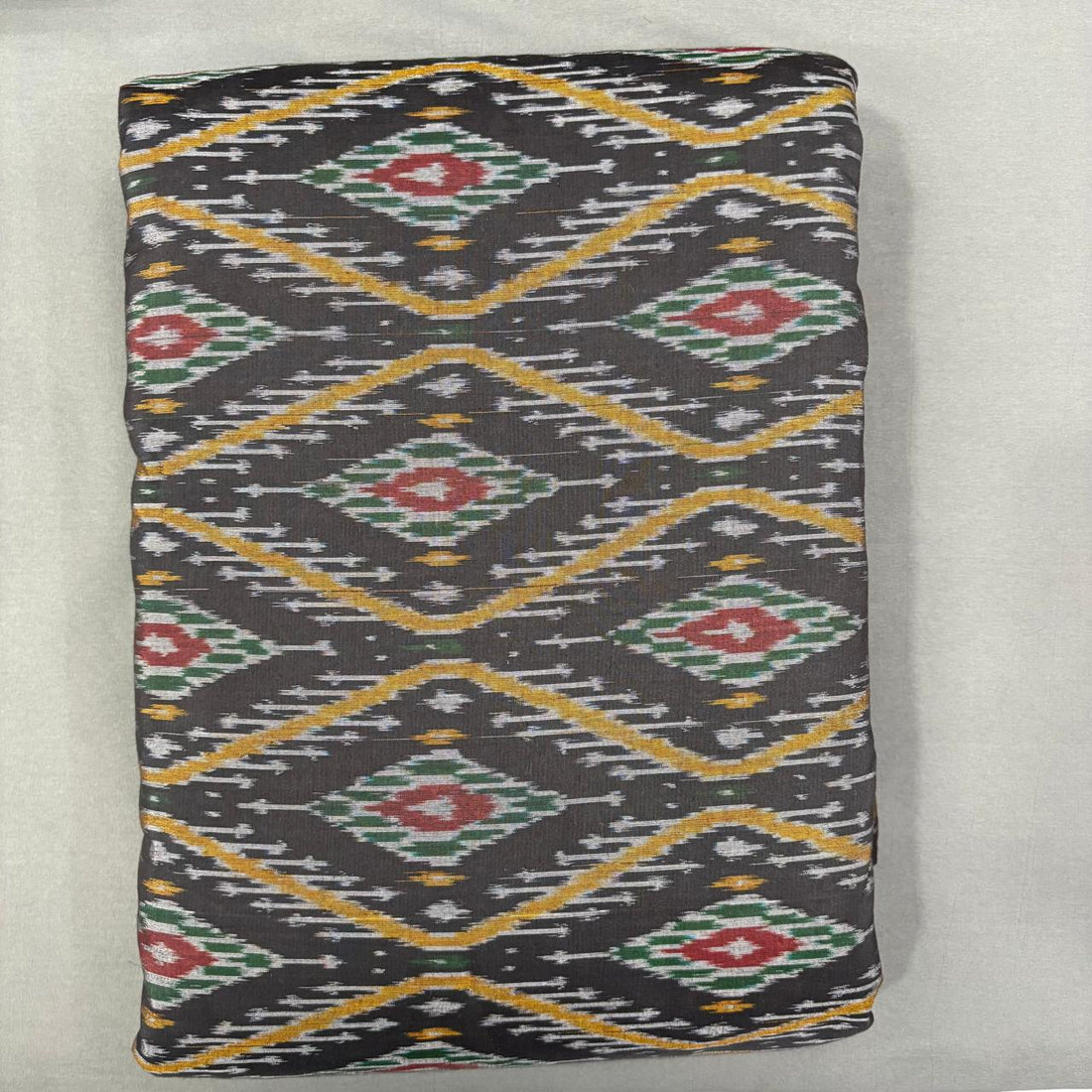 Handwoven Pochampally Ikkat Sico black fabric with bold yellow diamond grid and multicolor motifs