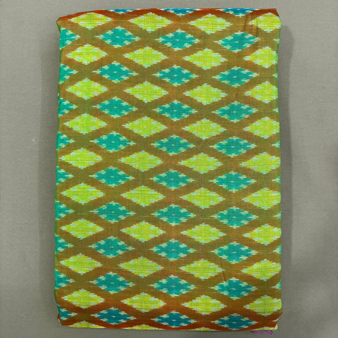 Handwoven Pochampally Ikkat Sico dress material fabric with lime green and teal diamond patterns on olive base