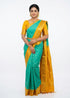 Model showcasing a full front view of a Pure Gadwal Silk Saree in turquoise blue and mustard yellow