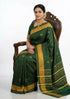 A traditional pure green Patola silk saree draped elegantly, showcasing gold elephant and bird motifs with a broad geometric zari border.