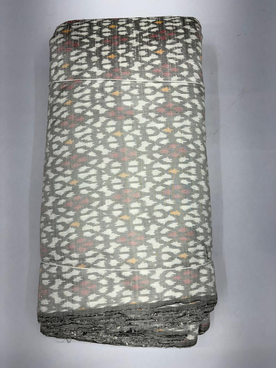 Folded bolt of ash grey pure raw silk fabric featuring an all-over geometric micro-Ikat weave with Silk Mark authenticity