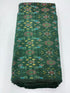 Folded bolt of bottle green pure raw silk fabric featuring vibrant multicolor floral Ikat motifs with Silk Mark quality weave