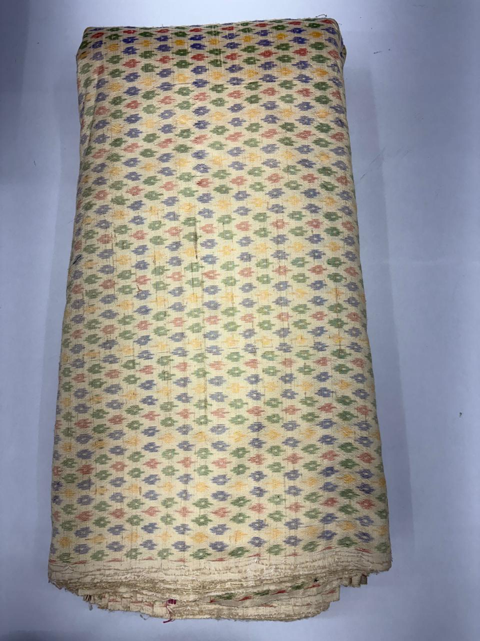 Folded bolt of cream pure raw silk fabric featuring all-over multicolor pastel geometric Ikat buttis with Silk Mark authenticity