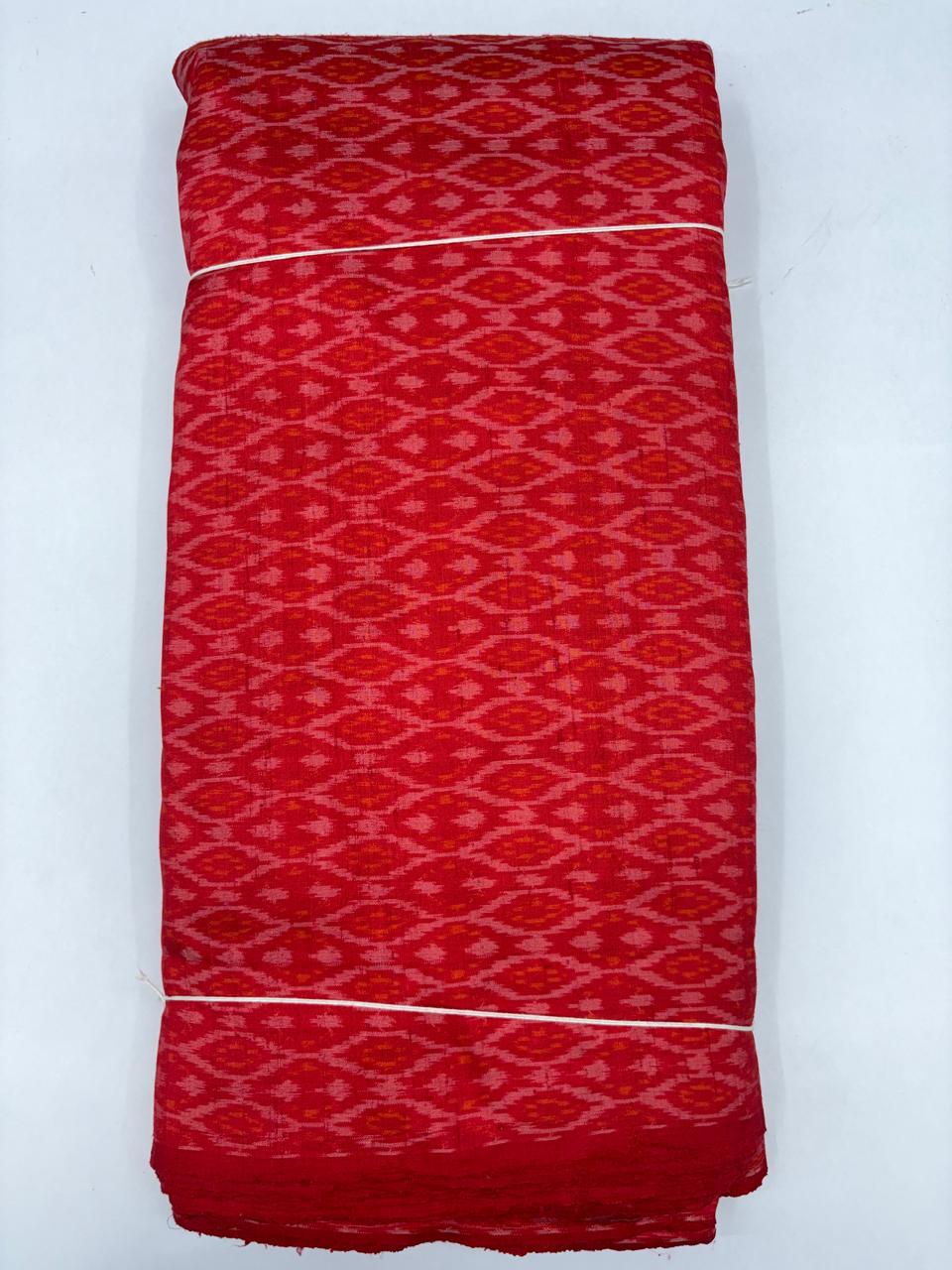 Folded bolt of vibrant crimson red pure raw silk fabric featuring an all-over diamond lattice Ikat weave with Silk Mark authenticity