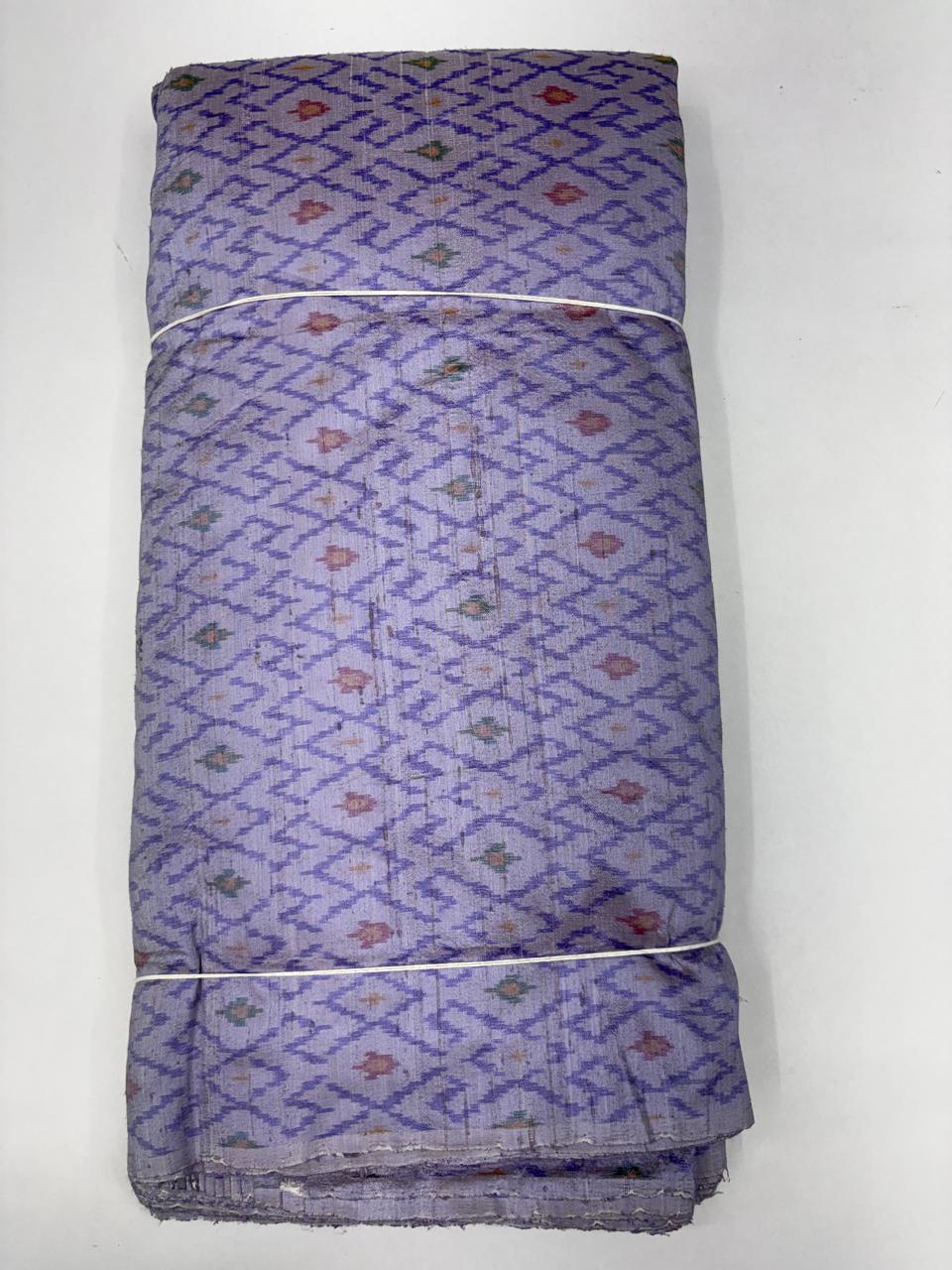 Folded bolt of lavender lilac pure raw silk fabric featuring an interlocking geometric diamond lattice Ikat weave with Silk Mark authenticity