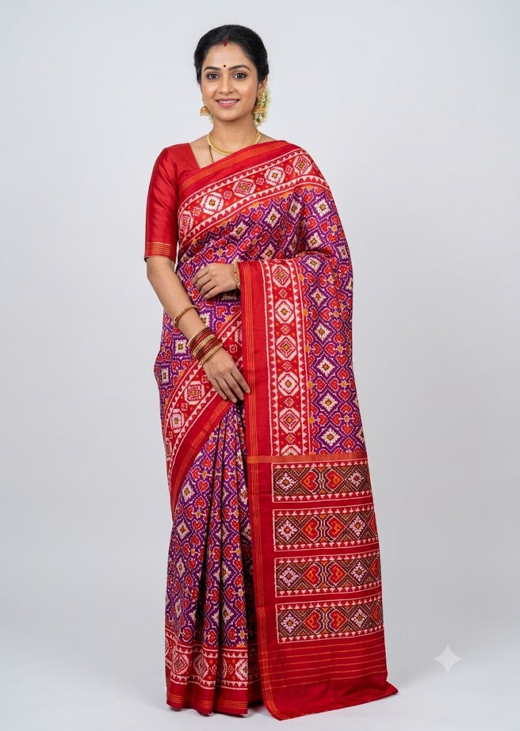 Indian model wearing a magenta and crimson red pure Ikkat silk Patola saree with matching blouse
