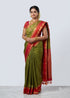 Traditional woman modeling a pure Kanchipuram silk saree in olive green with a rich crimson red gold zari border and brocade pallu with Silk Mark certification.