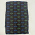 Folded black handwoven pure silk Ikat fabric featuring vibrant royal blue and emerald green geometric diamond patterns with Silk Mark certification.